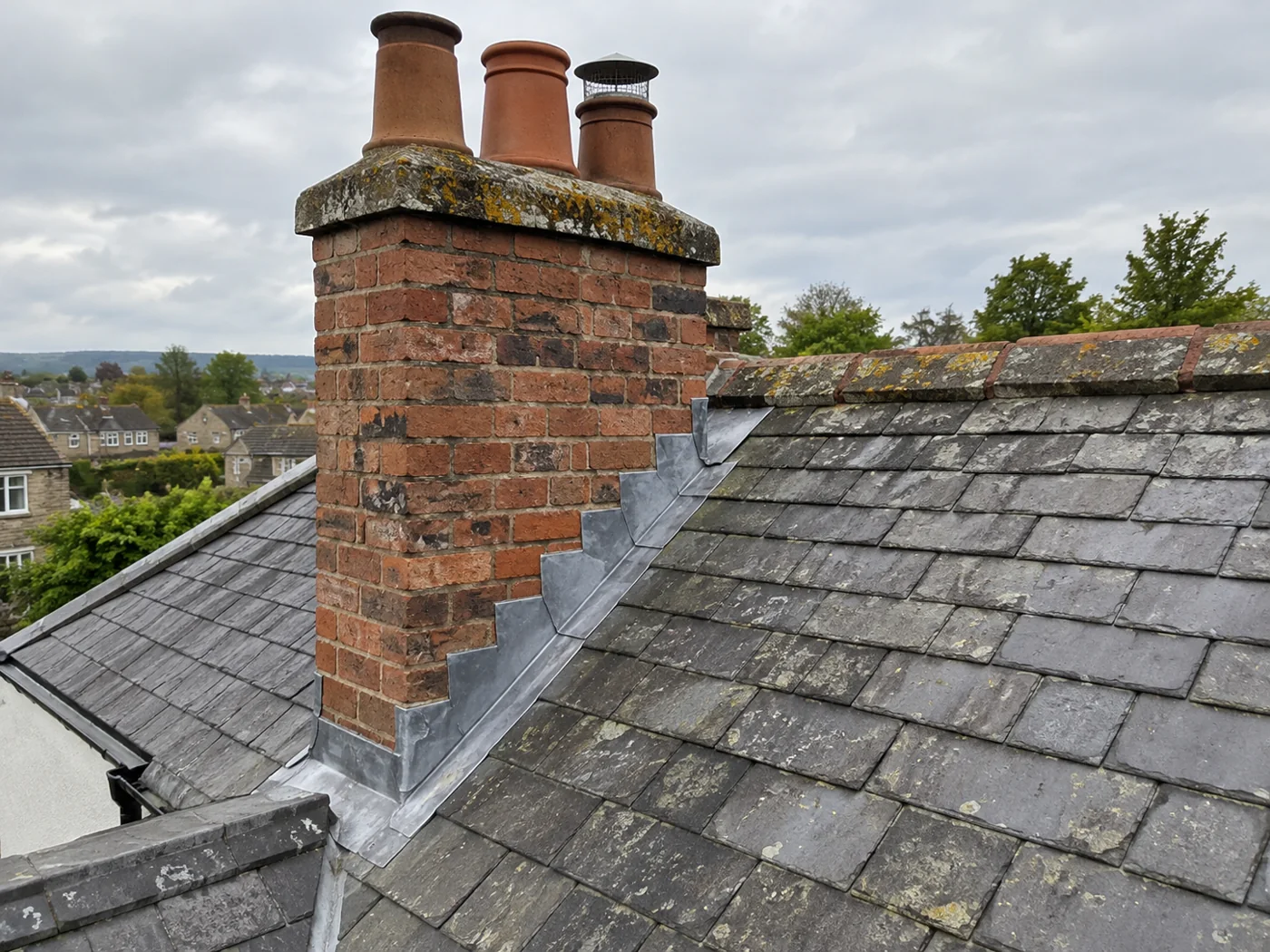 Brick chimney with pots and stepped lead flashing